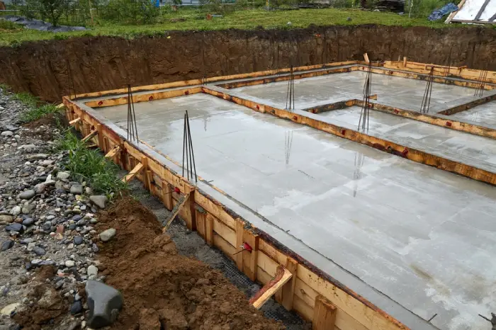 Concrete foundation with wooden forms and rebar for new home construction